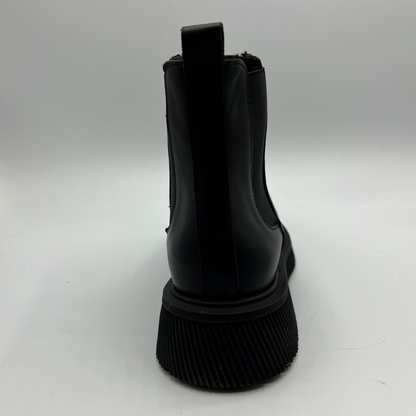 Black short boot with a chunky sole  on a white background