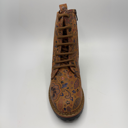Front facing view of a tan boot with a floral motif, stacked heel and matching laces