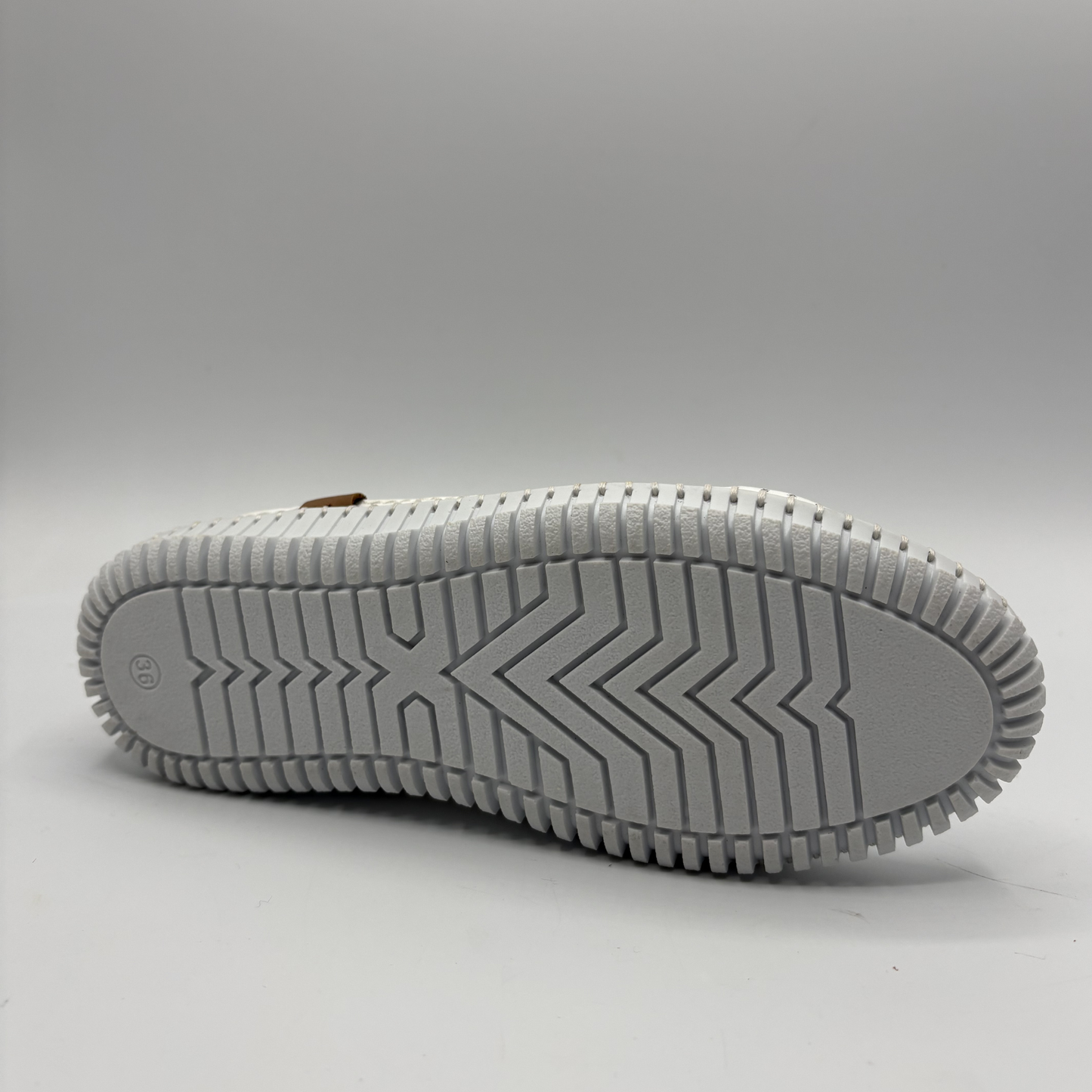 Bottom view of an orange lace up sneaker