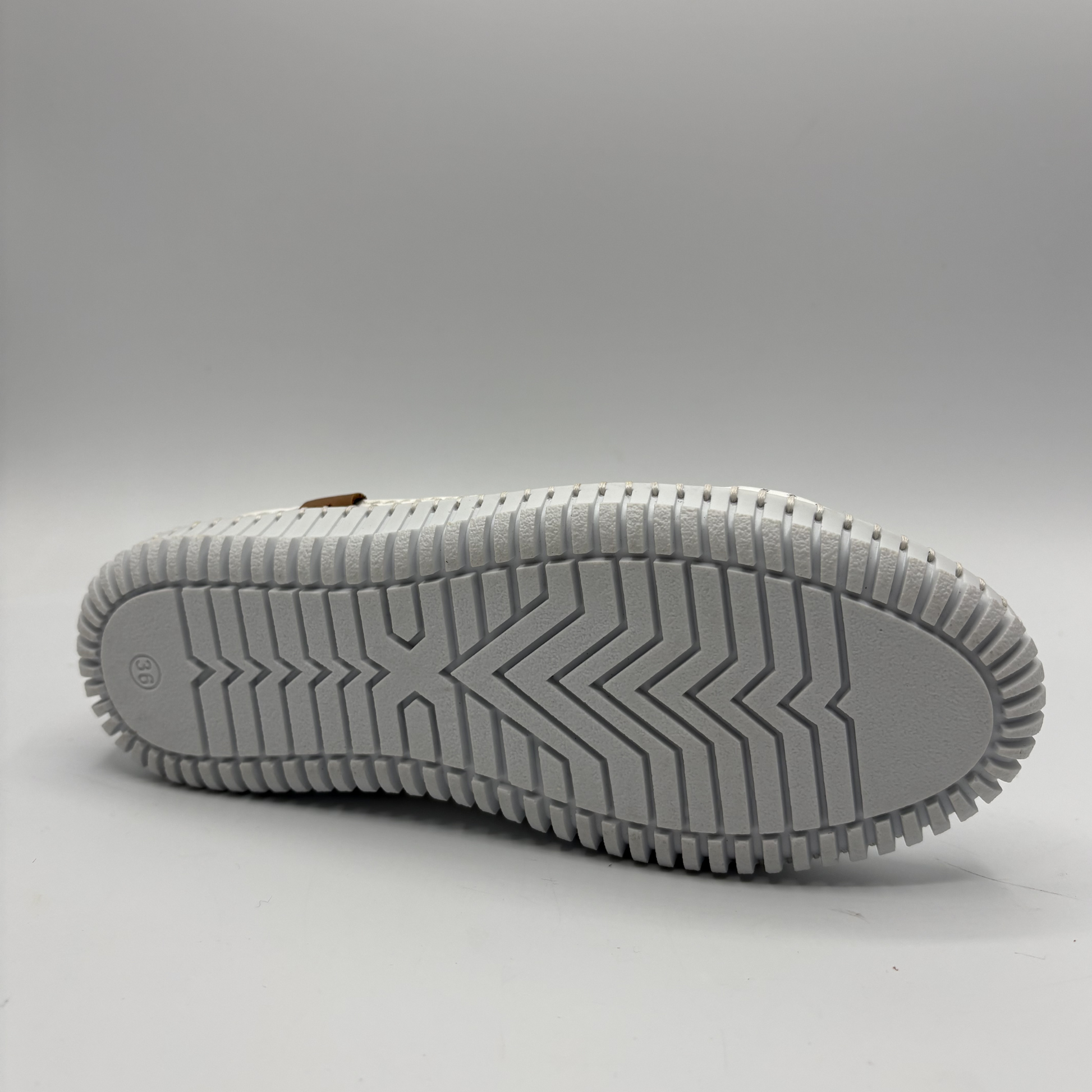 Bottom view of an orange lace up sneaker