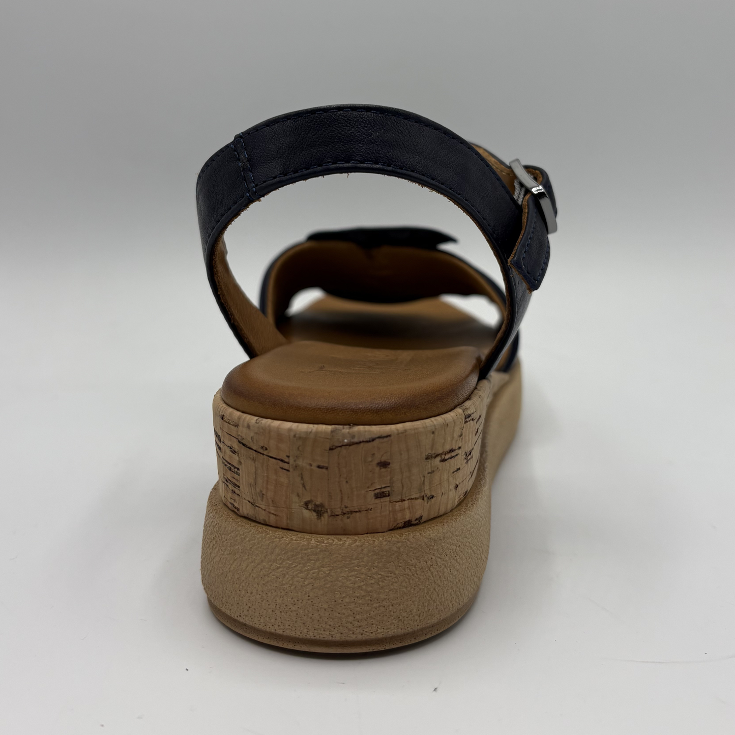 Brown sandal with cork wedge sole on a white background