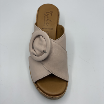 Beige sandal with a circular design on a white background