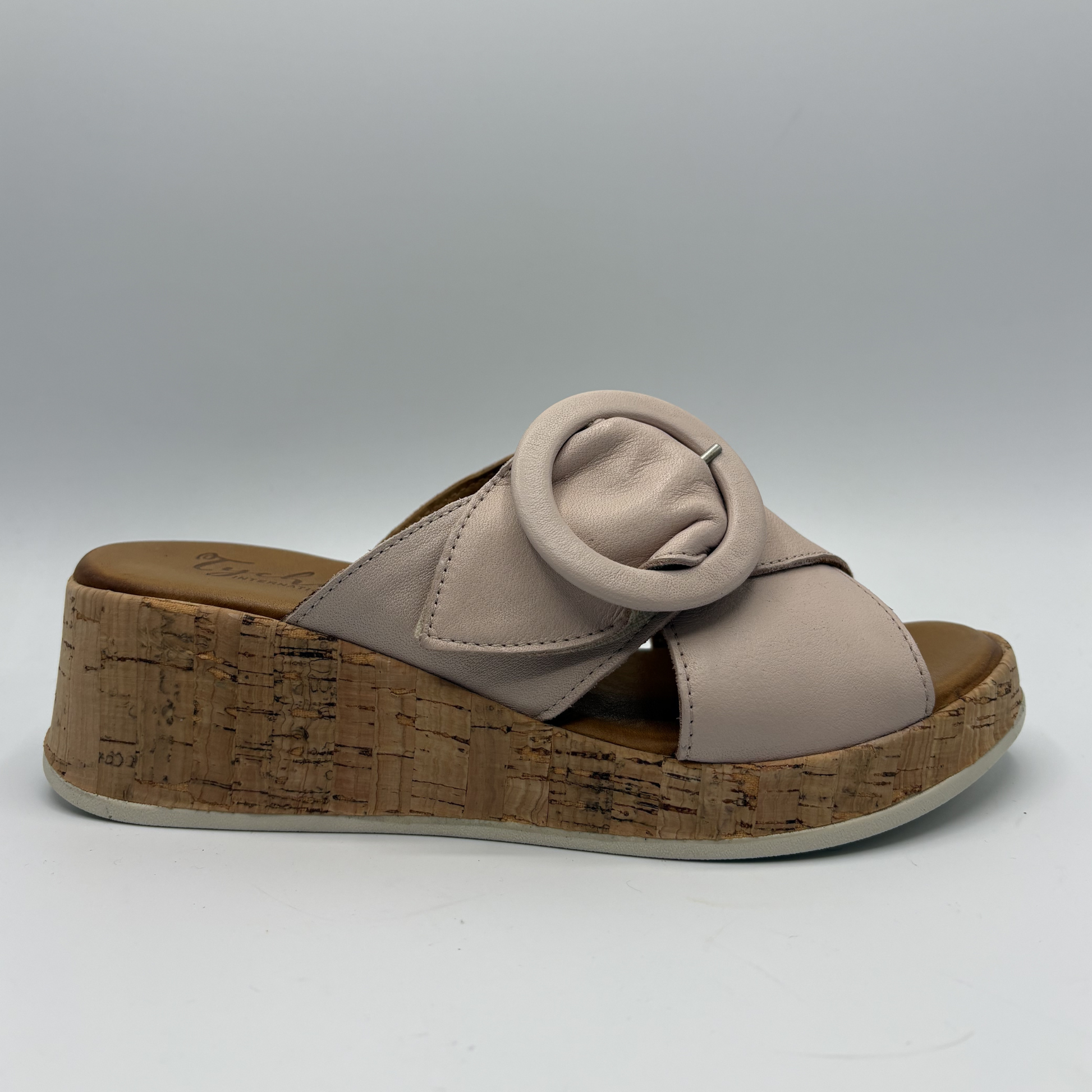 Beige sandal with cork platform on a white background