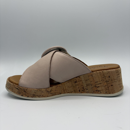 Beige sandal with cork wedge sole on a white background