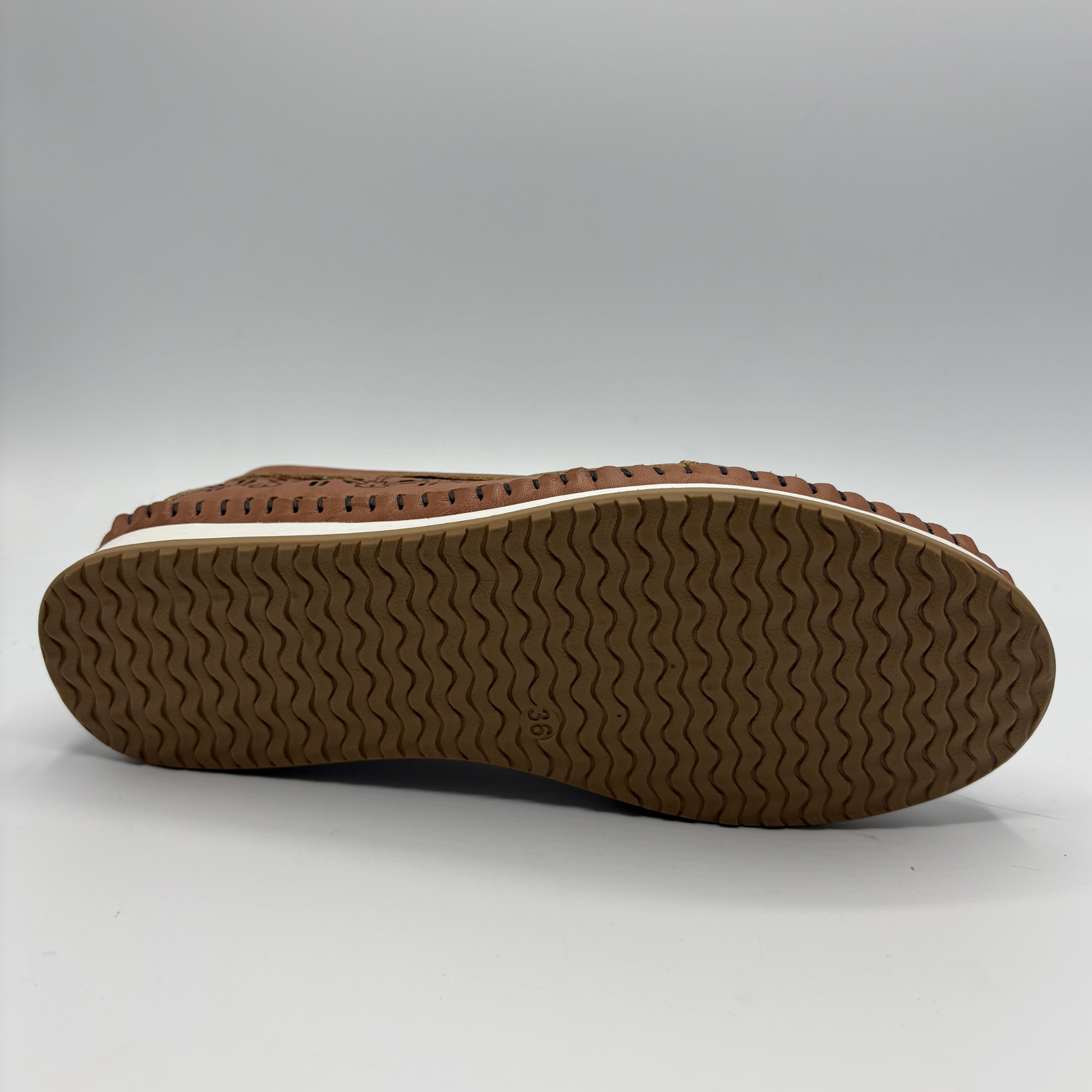 Bottom view of a brown leather slip on shoe