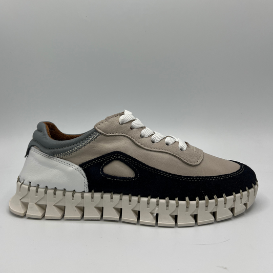 Right facing view of a leather sneaker with  navy, grey, white and taupe colours on the upper, functional white lace up design and a white rubber outsole