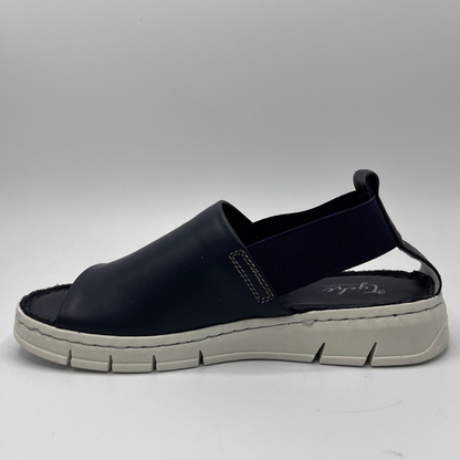 Left facing view of a slip on shoe with elasticated side bands, peep toe and a white rubber outsole.