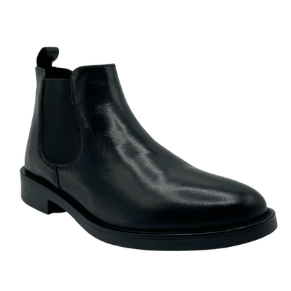45 degree angled view of black leather chelsea boot with black outsole and elastic side gore