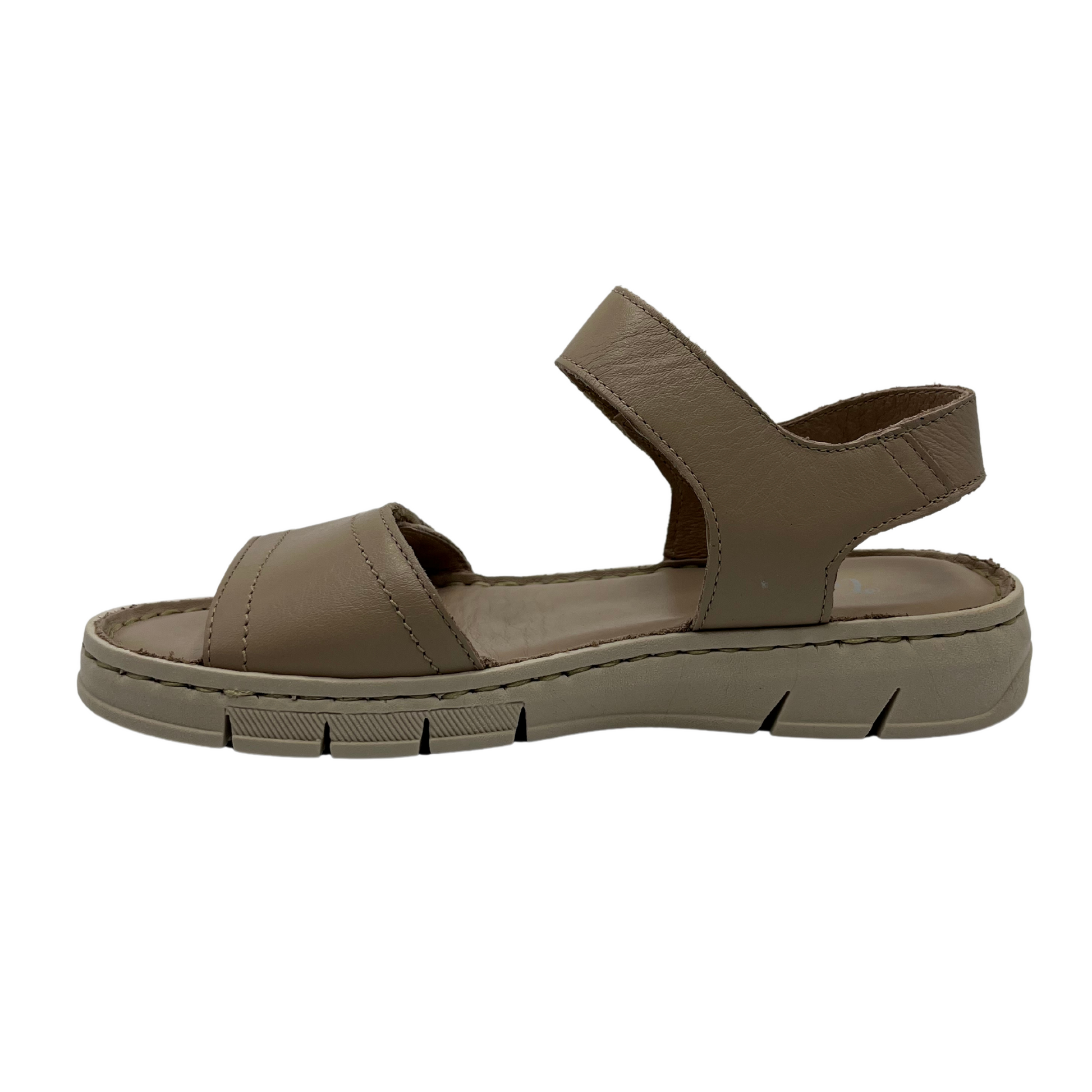 Left facing view of taupe leather sandal with rubber outsole and adjustable velcro straps