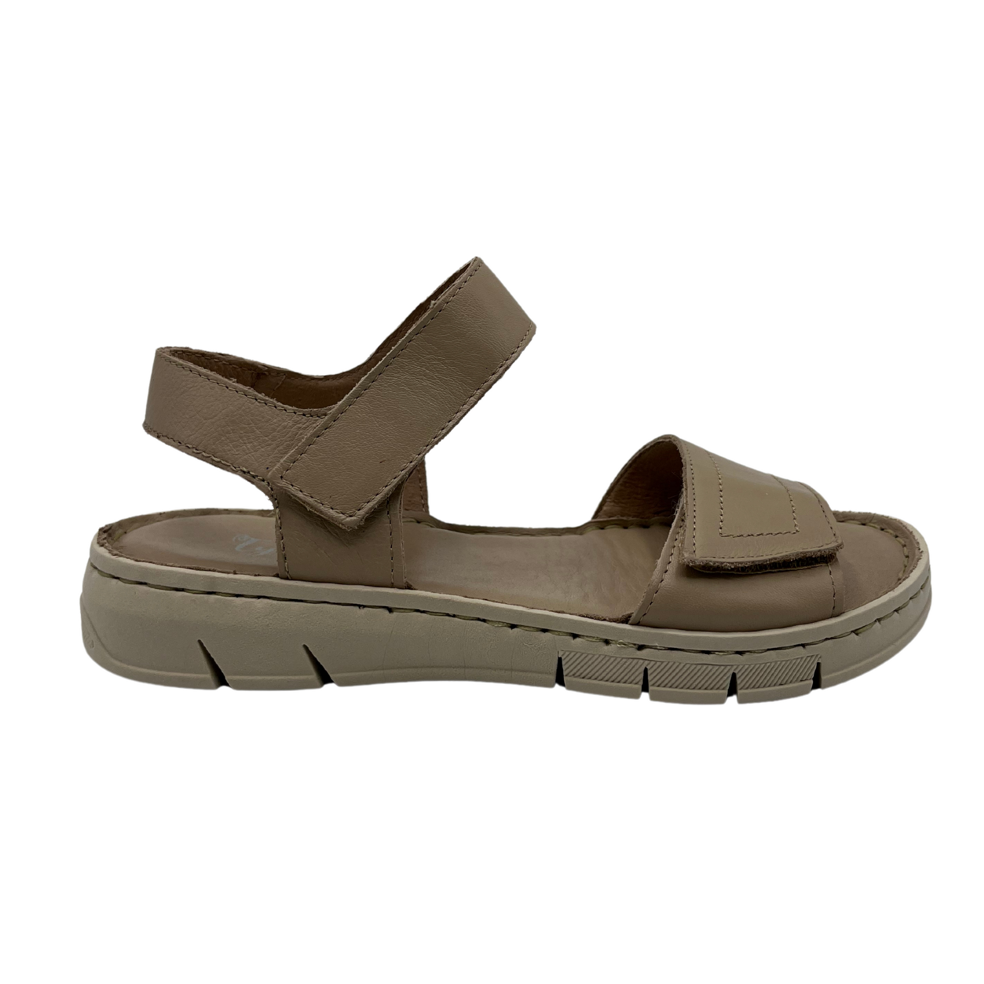 Right facing view of taupe leather sandal with rubber outsole and adjustable velcro straps