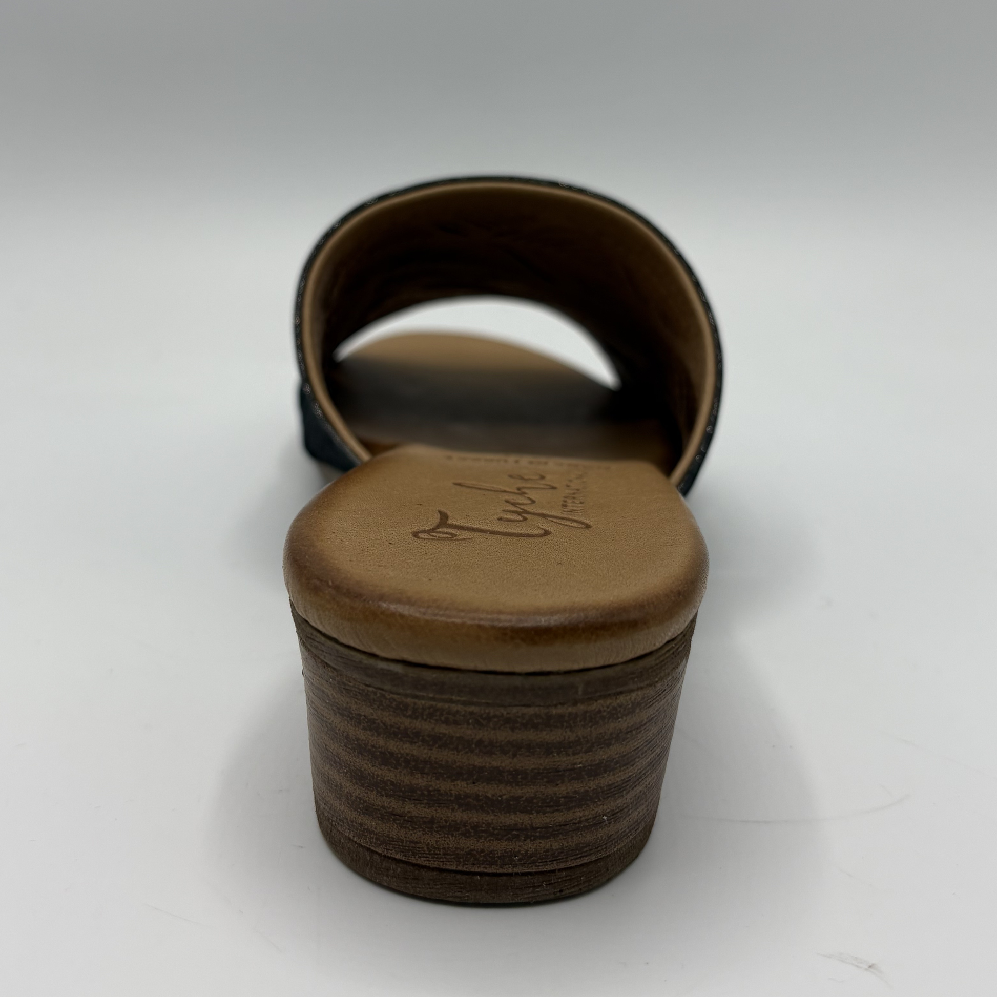 Brown leather sandal with a strap on a white background