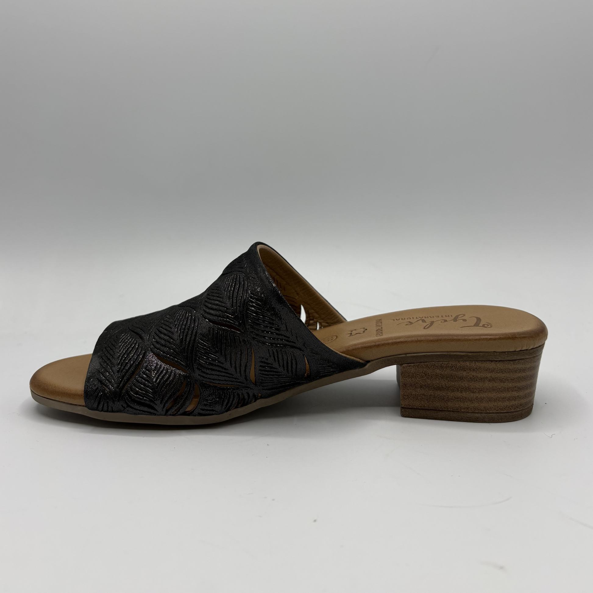 Black sandal with brown sole on a white background