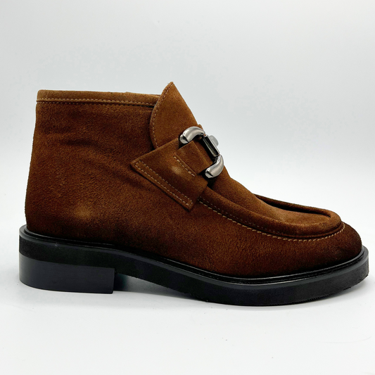 Brown suede shoe with a black sole on a white background