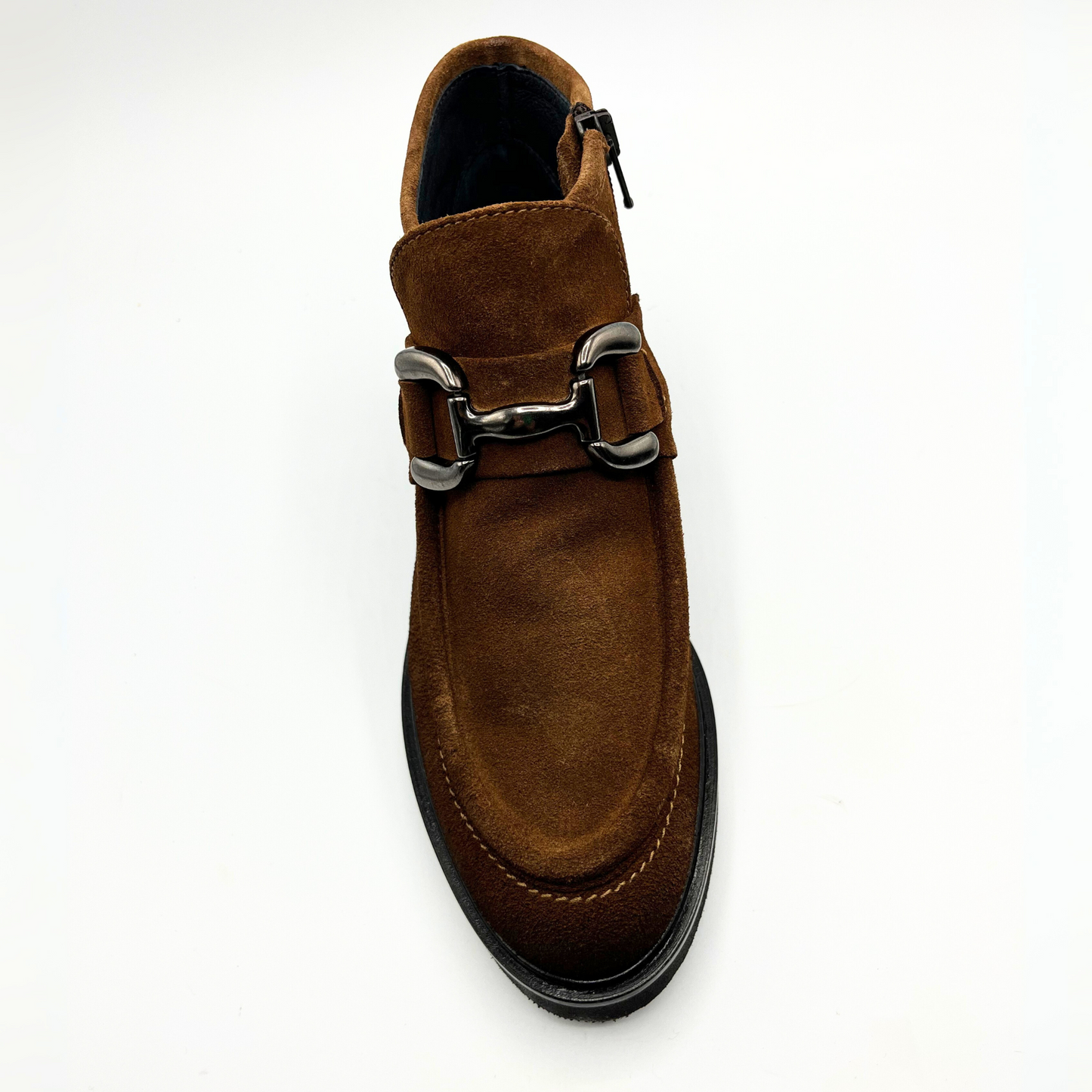 Brown suede boot with silver buckle on a white background