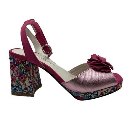 Right facing view of leather and satin material sandal with block heel and platform sole. Flower accent on toe and adjustable ankle strap