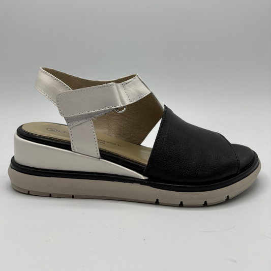 Black and white sandal on a gray background