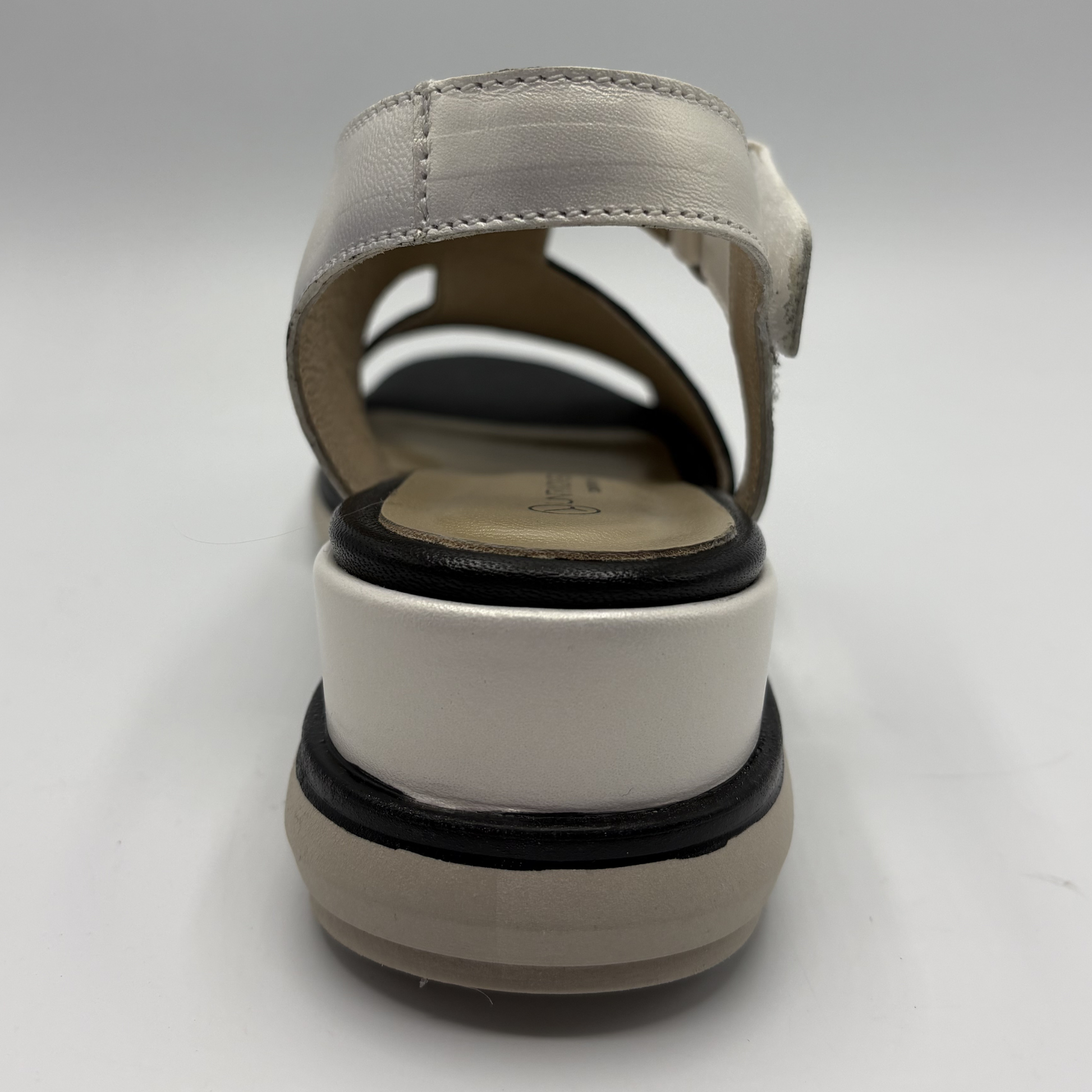 Black and white sandal on a light gray background