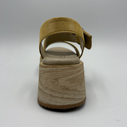 Yellow sandal with a thick sole on a white background