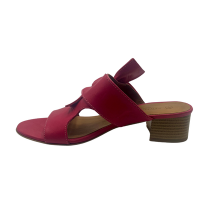 Left facing view of fuchsia pink leather sandal with a block heel, peep toe and knot detail on upper.