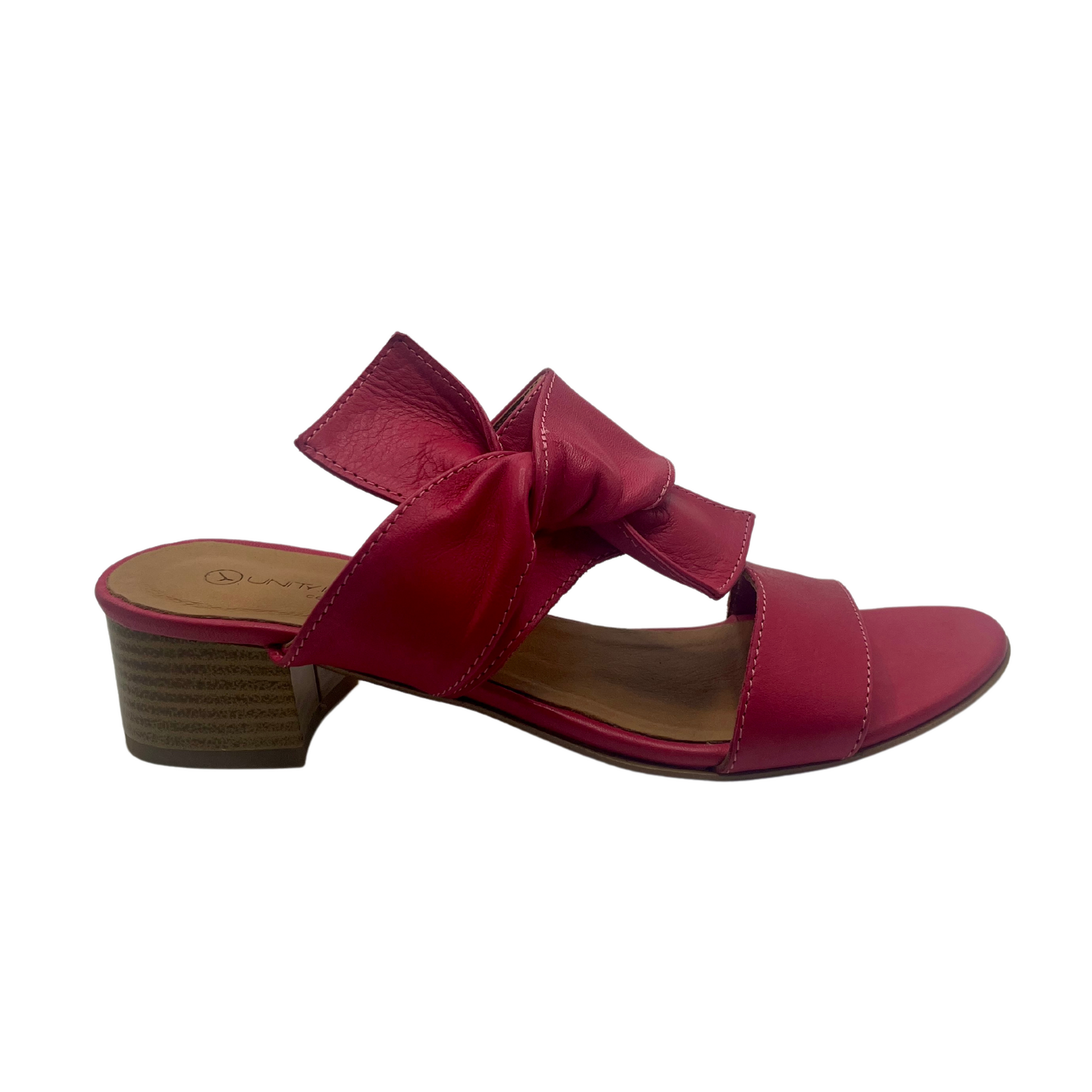 Right facing view of pink fuchsia leather sandals with a block heel, peep toe and knot detail on upper. 