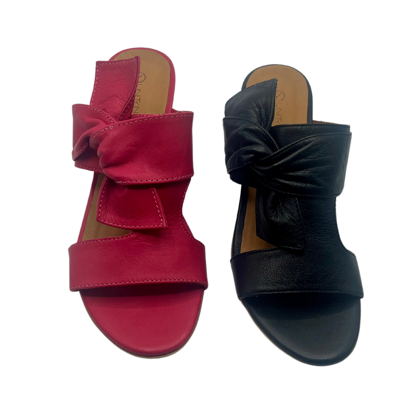 Top view of two leather sandals side by side. One is fuchsia pink leather and one is black leather. Both have a block heel, peep toe and knot detail on upper.
