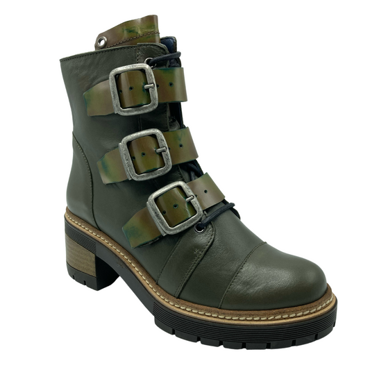 45 degree angled view of khaki green leather boot with 3 buckle detail and chunky rubber heel and sole