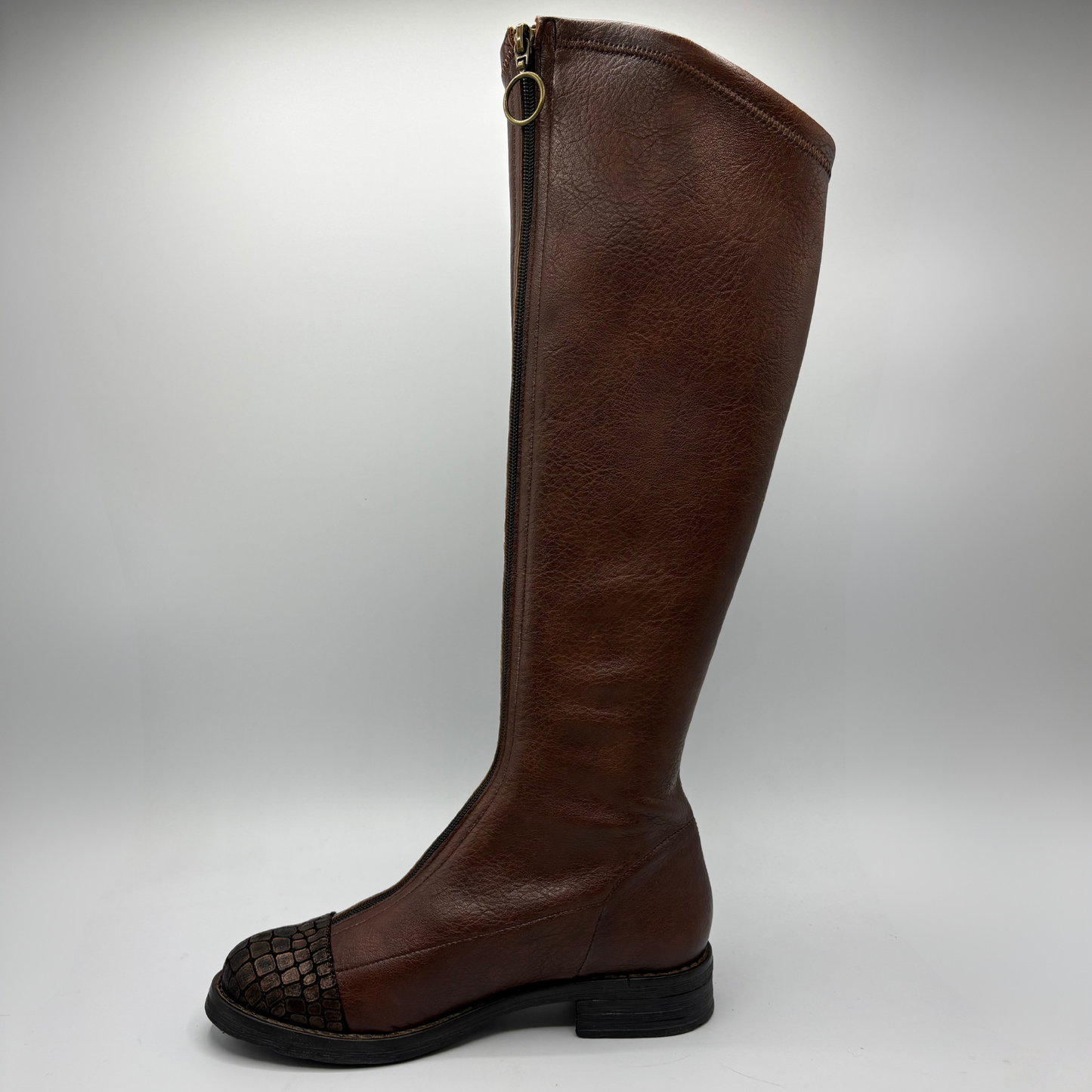 A single knee-high brown leather boot with a dark brown crocodile textured toe cap and a black sole, shown from a side profile against a light gray background.