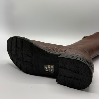 A single knee-high brown leather boot with a dark brown crocodile textured toe cap and a black sole, shown from the bottom  against a light gray background.