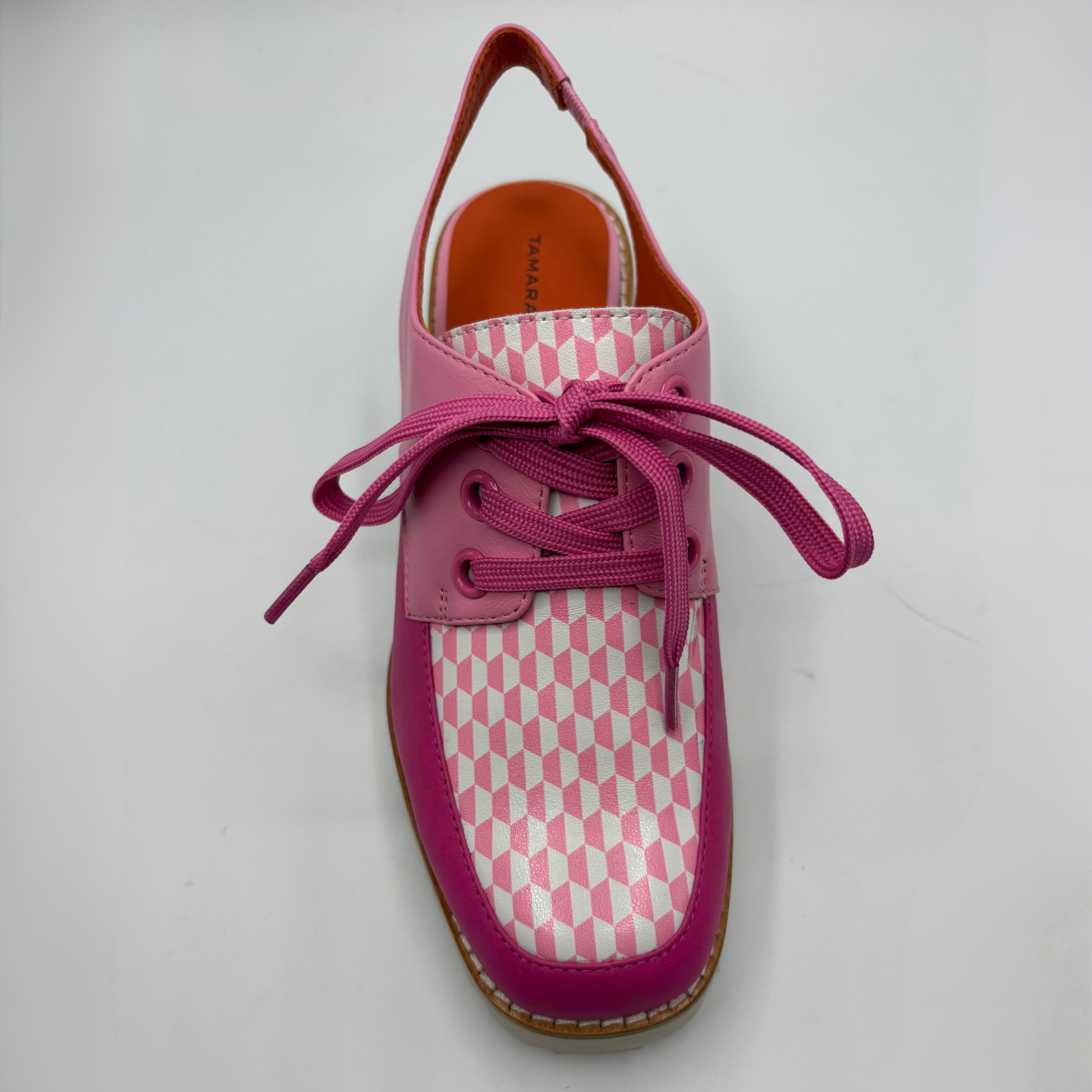 Pink checkered shoe with pink laces on a white background
