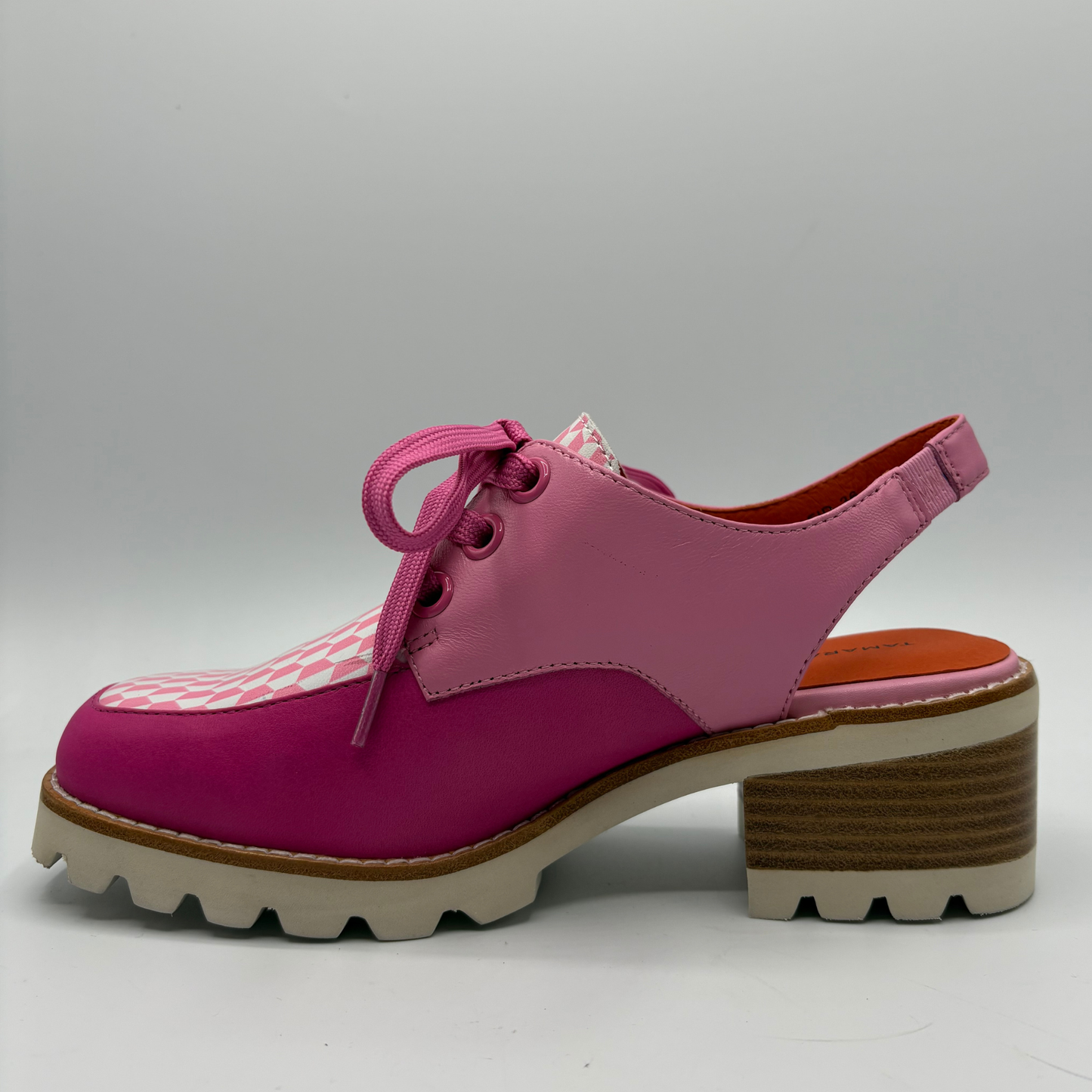 Pink shoe with a checkered accent on a gray background