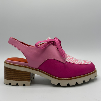 Pink and fuschia shoe with a checkered pattern on a gray background