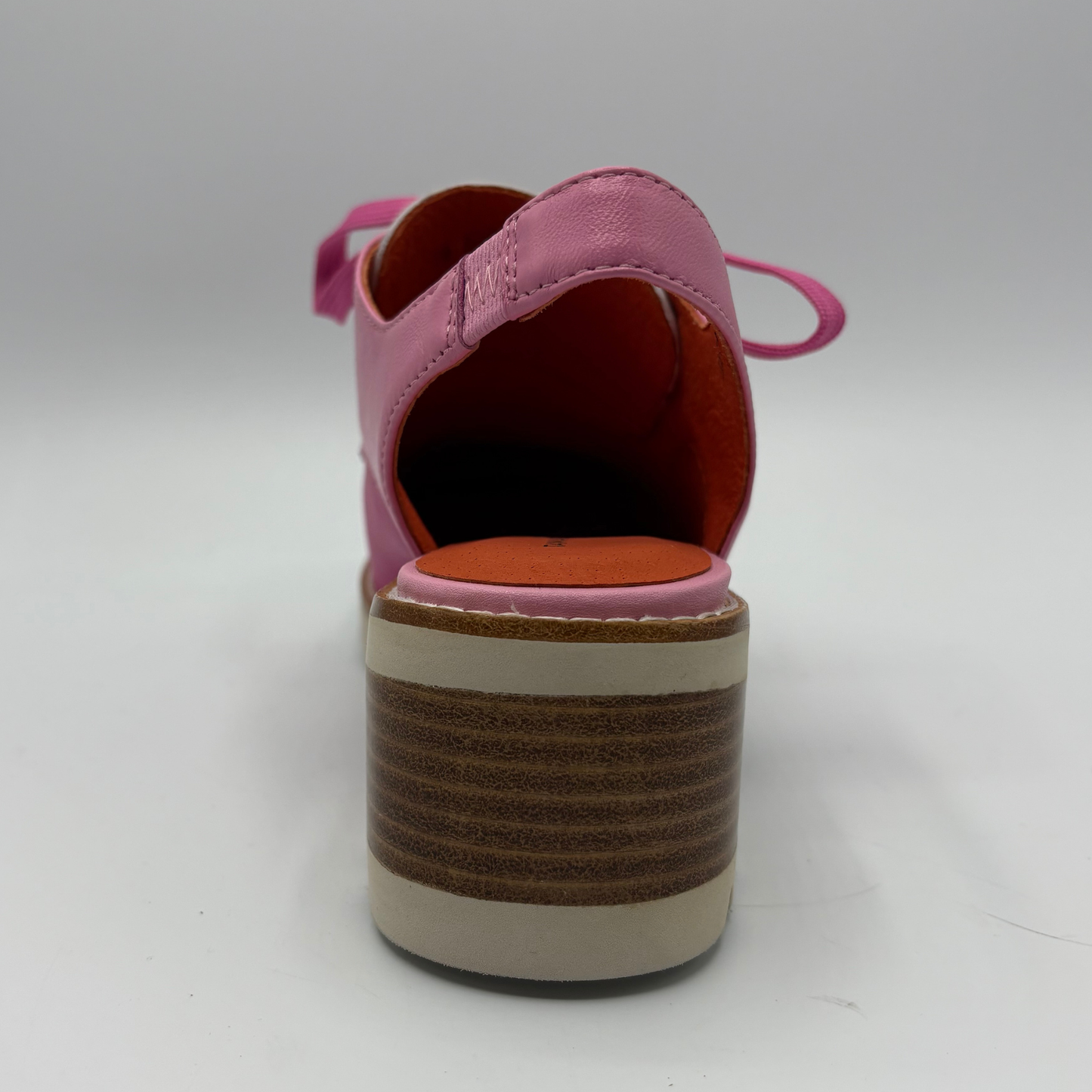 Pink shoe with a brown sole on a white background