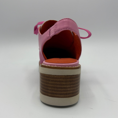 Pink shoe with a brown sole on a white background