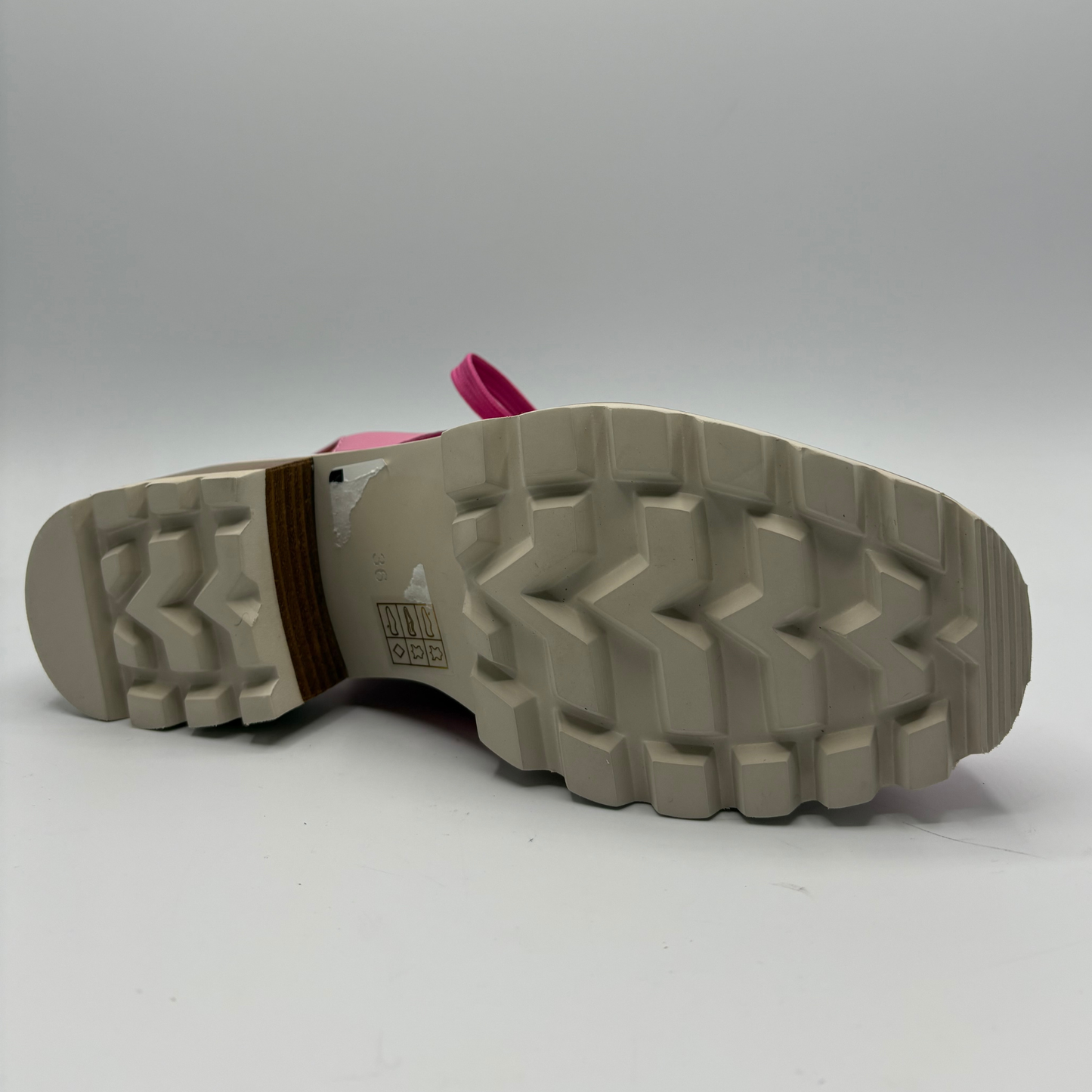 Close-up of a shoe sole with brand logo on a white background