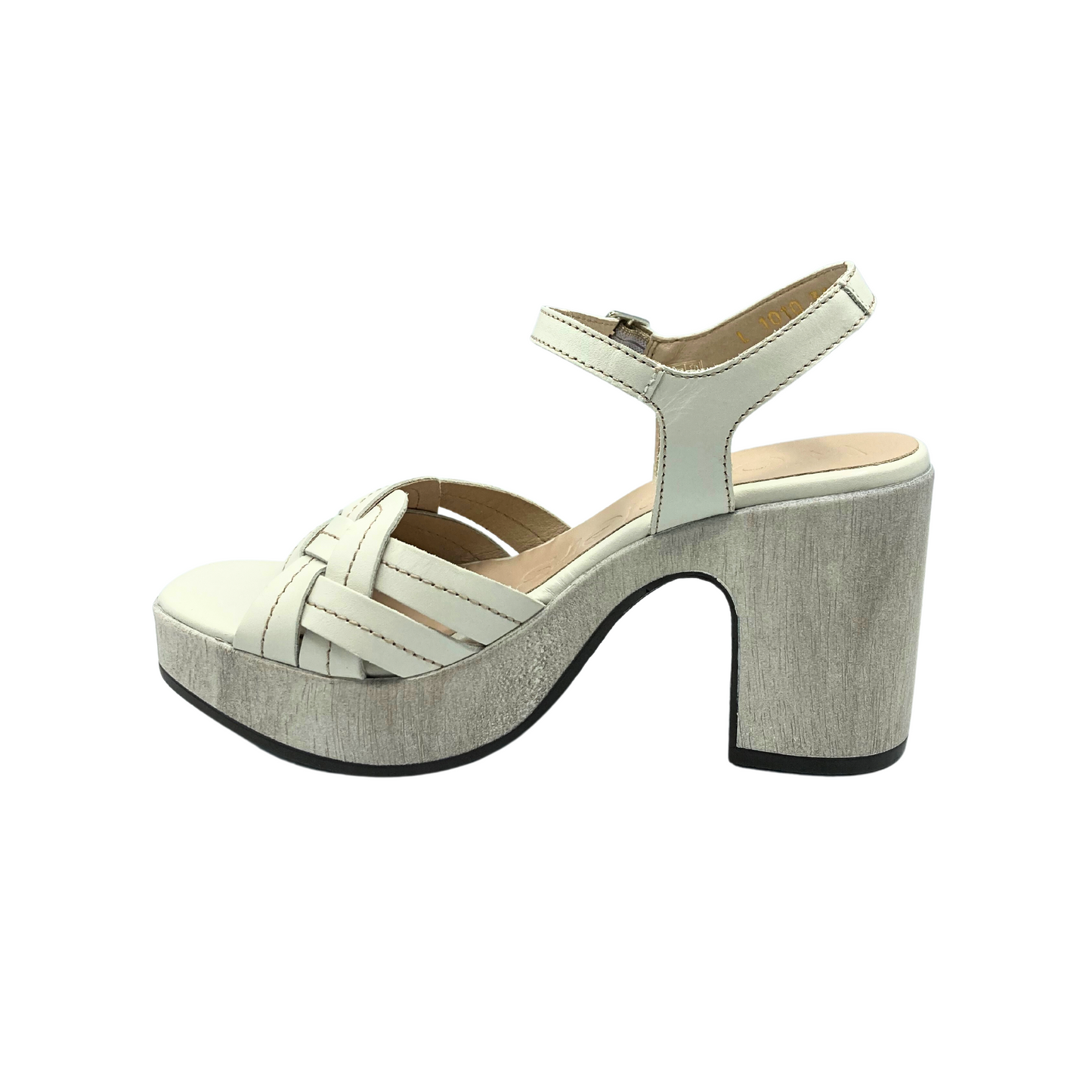 Inside view of a platform sandal.  Creamy white leather upper is woven at the front and offers great coverage at the forefoot.  Ankle and heel strap are attached with an adjustable buckle