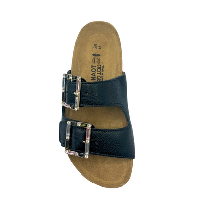 Top down view of a black leather sandal with big square adjustable buckles 