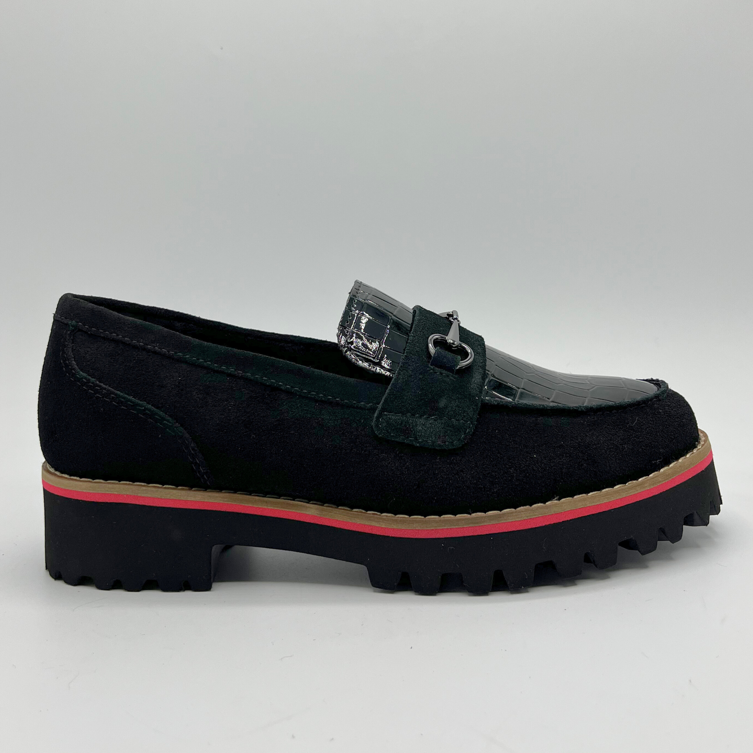 Black loafer shoe with a red sole on a light gray background