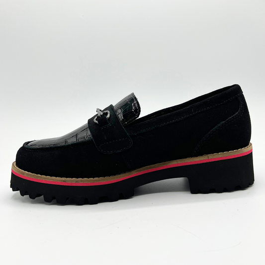 Black loafer shoe with a red sole on a white background