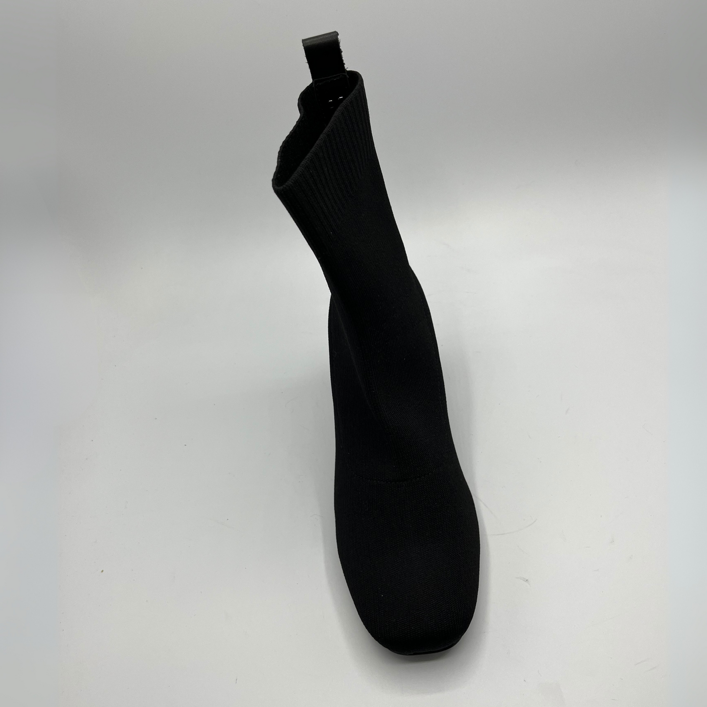 Black sock boot on a white background