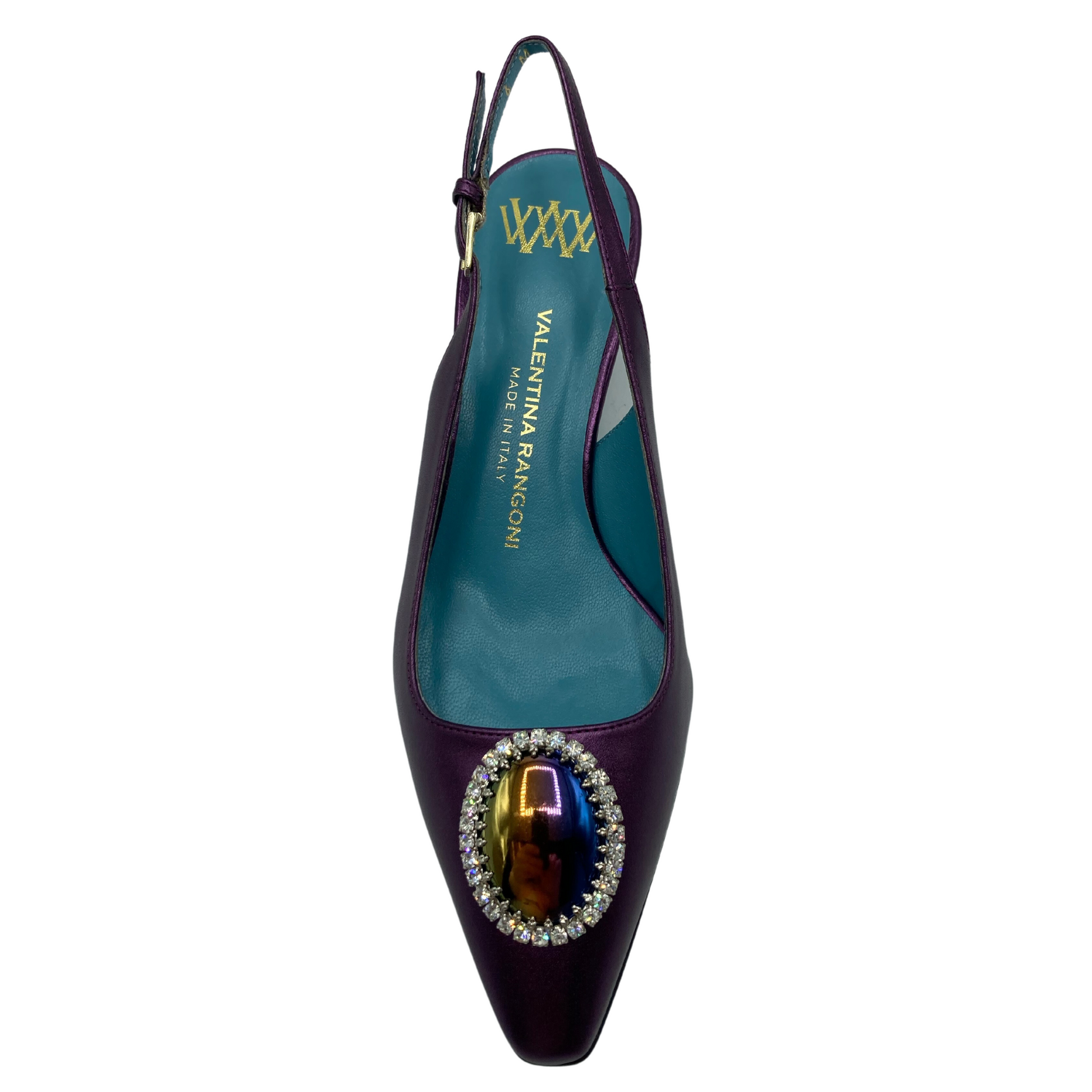 Top view of purple pointed toe pump with blue lining and oval jewelled detail on toe