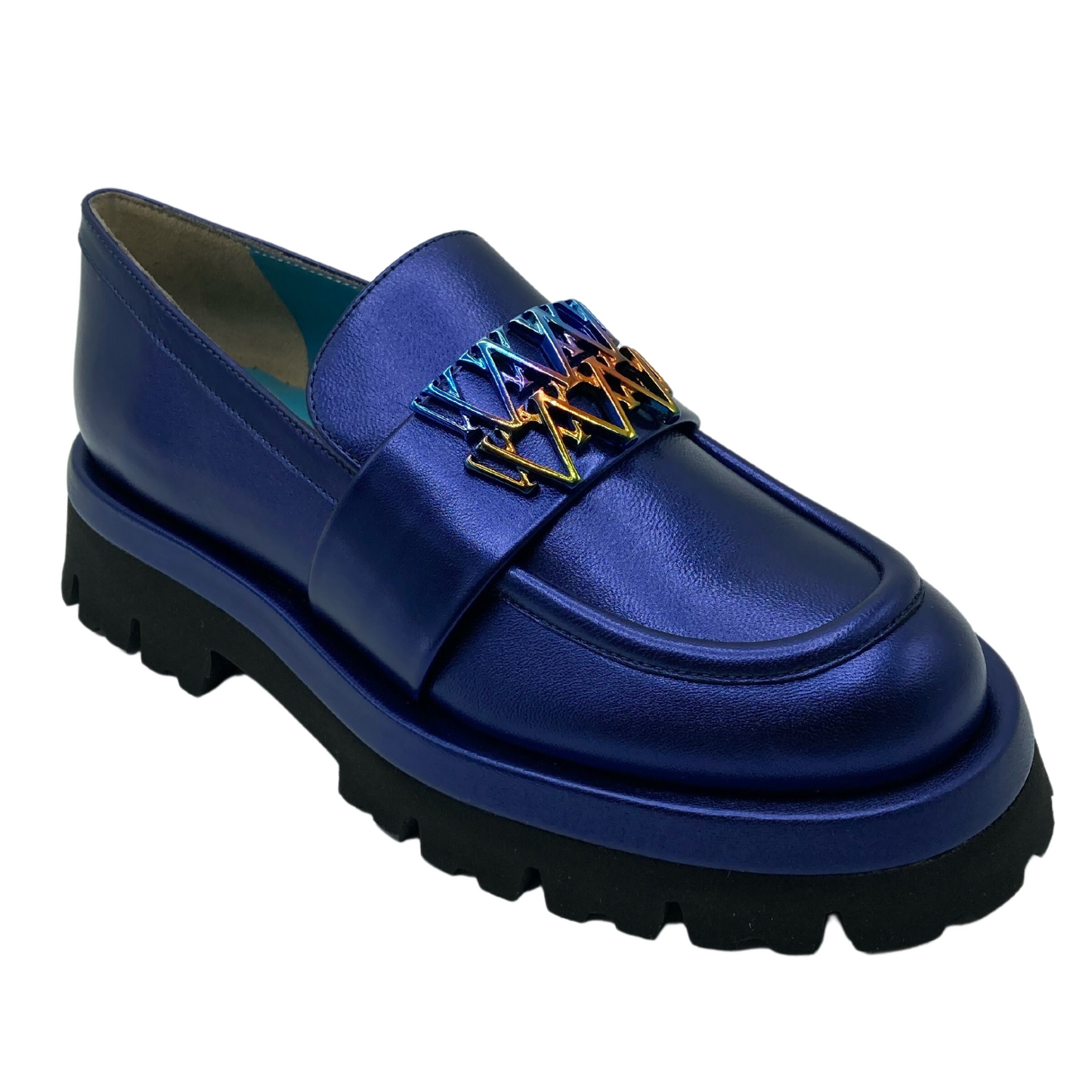 45 degree angled view of blue leather loafer with lugged rubber outsole and multicoloured detail on upper