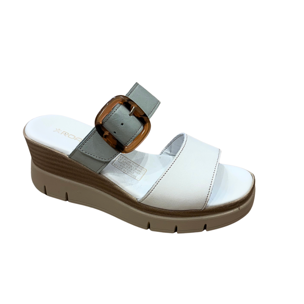 White sandal with a brown buckle on a white background