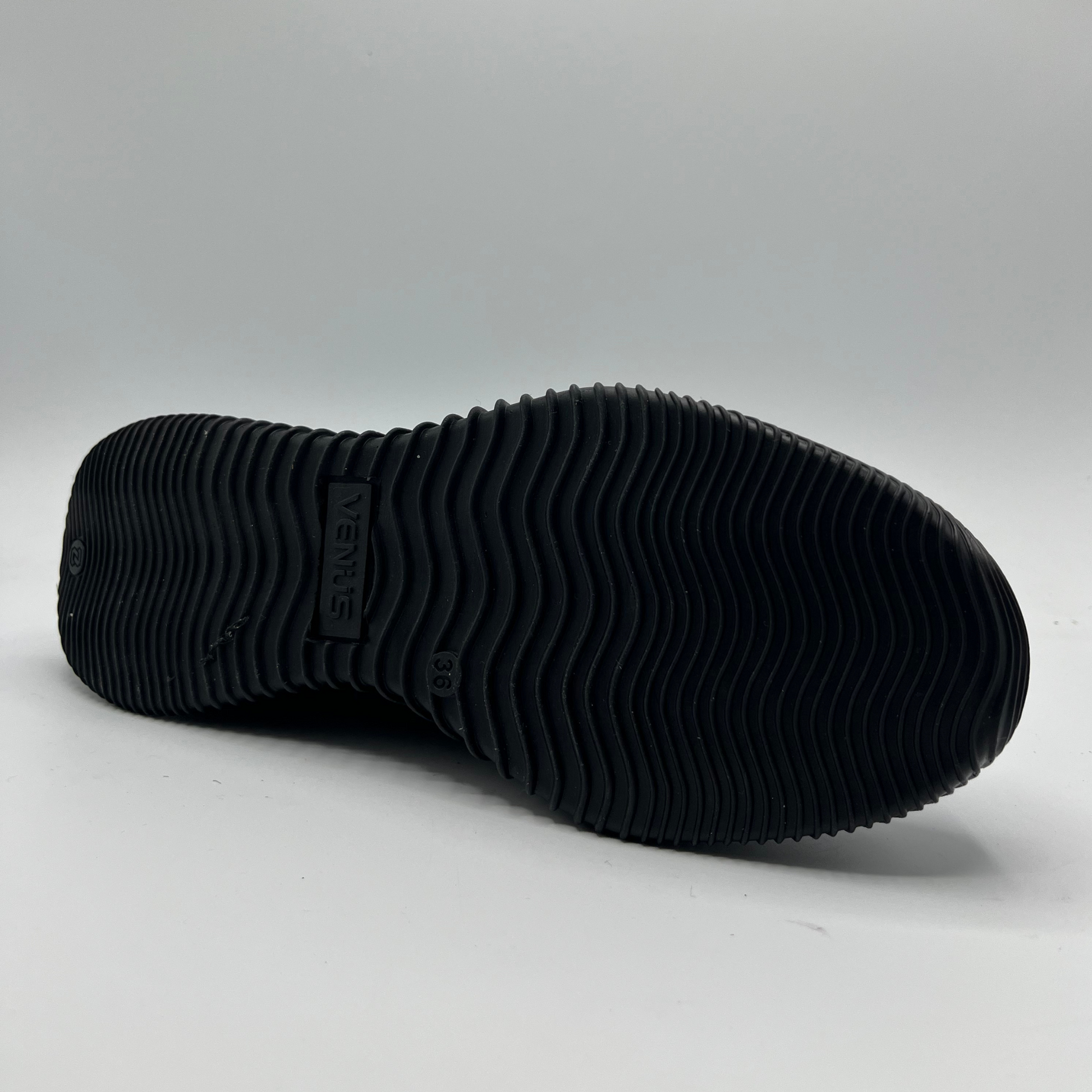 Black sole of a shoe on a gray background