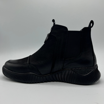 Black ankle boot on a light gray background