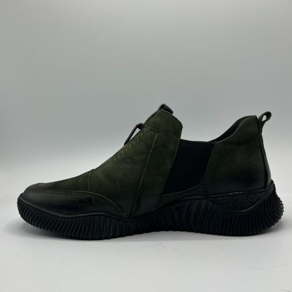 Dark green slip-on shoe on a gray background