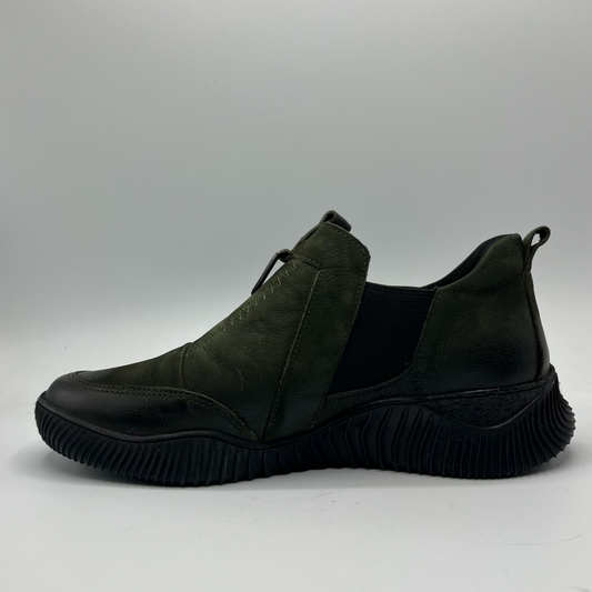 Dark green slip-on shoe on a gray background