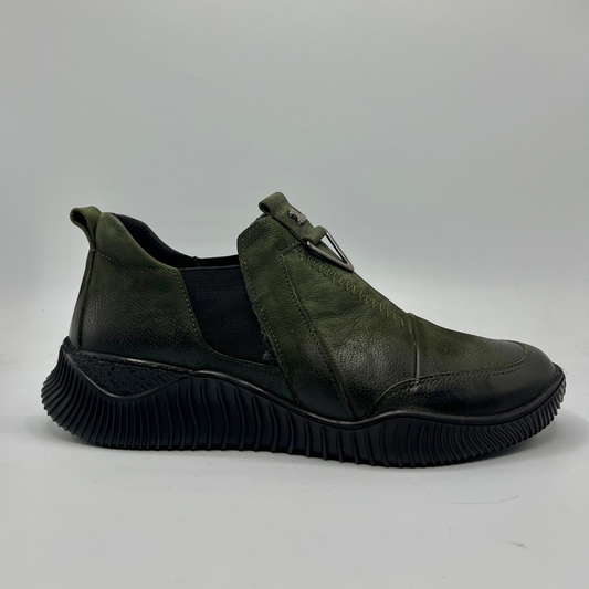 Green leather shoe with a thick sole on a light gray background