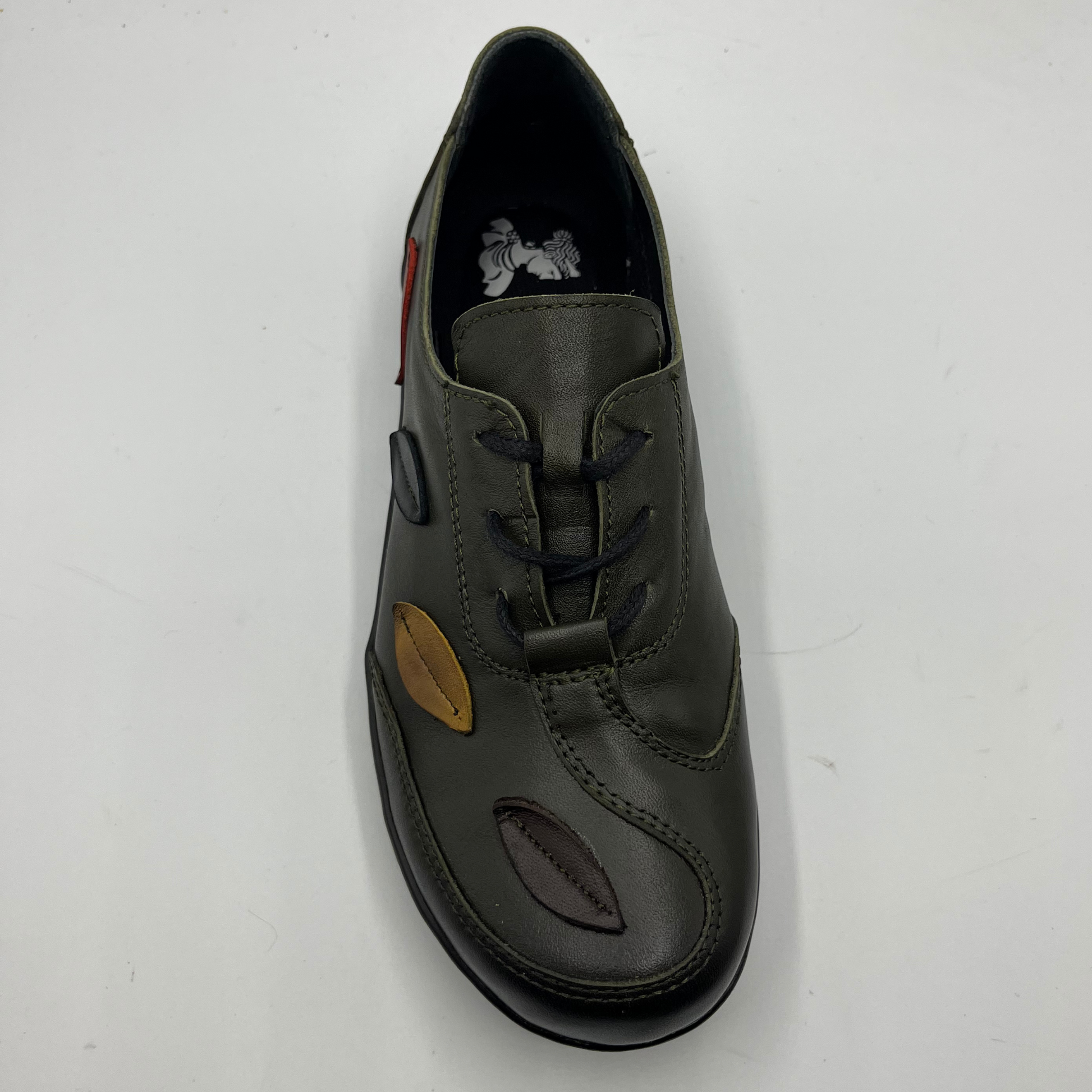 Olive shoe with a unique design on a white background