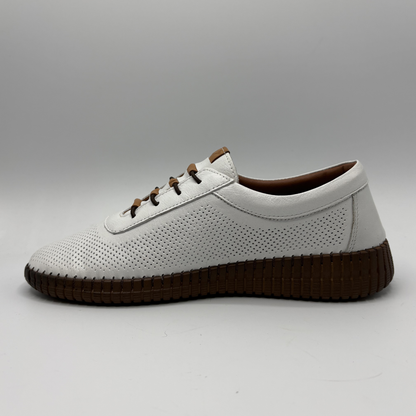 White shoe with brown sole on a gray background