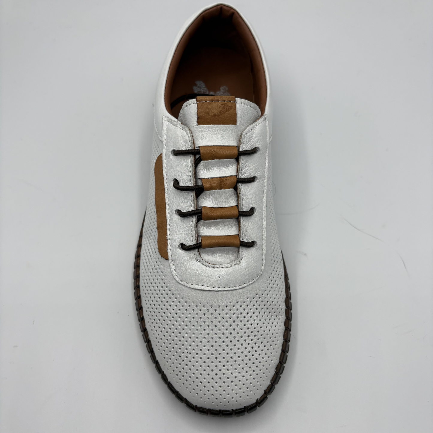 White shoe with brown accents on a light gray background